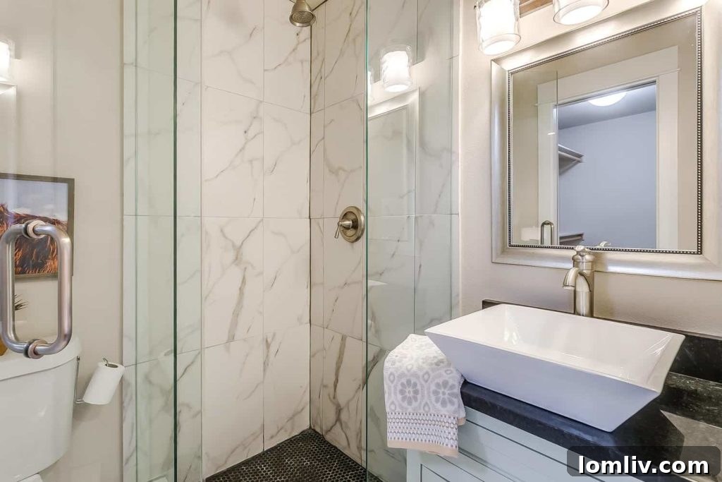 Updated master bathroom featuring contemporary fixtures and a spacious closet in the Fairmount bungalow
