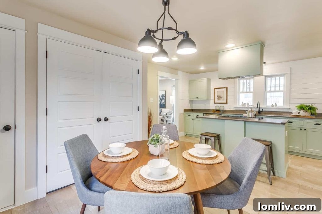 Modern kitchen with pistachio Shaker cabinetry, island gas range, and elegant finishes in the Fairmount home