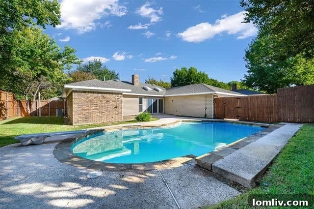 Inviting diving pool and patio in the backyard of a Plano home