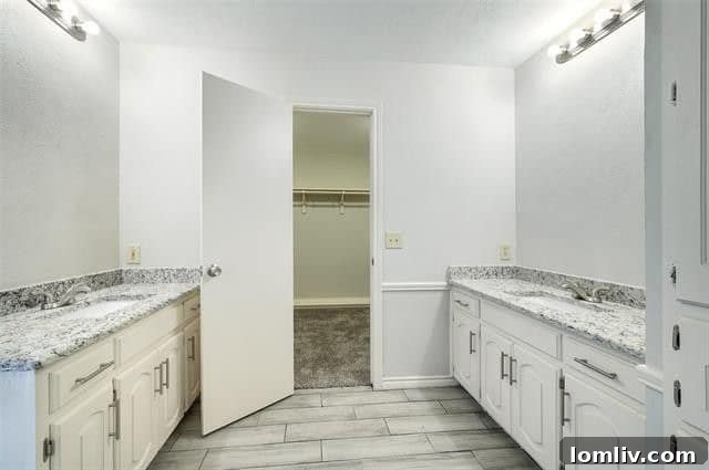 Remodeled master bathroom with dual vanities and stand-alone shower