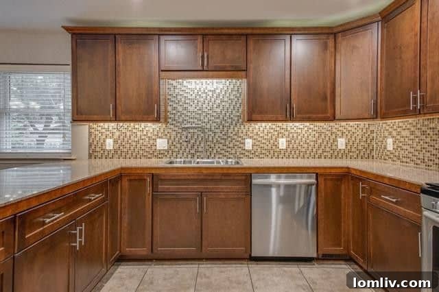 Updated kitchen with modern cabinetry and stainless steel appliances