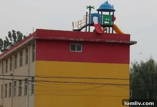 A massive slide extending from a rooftop playground to ground level