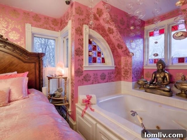 A bizarre bedroom setup with a bed directly next to a bathtub