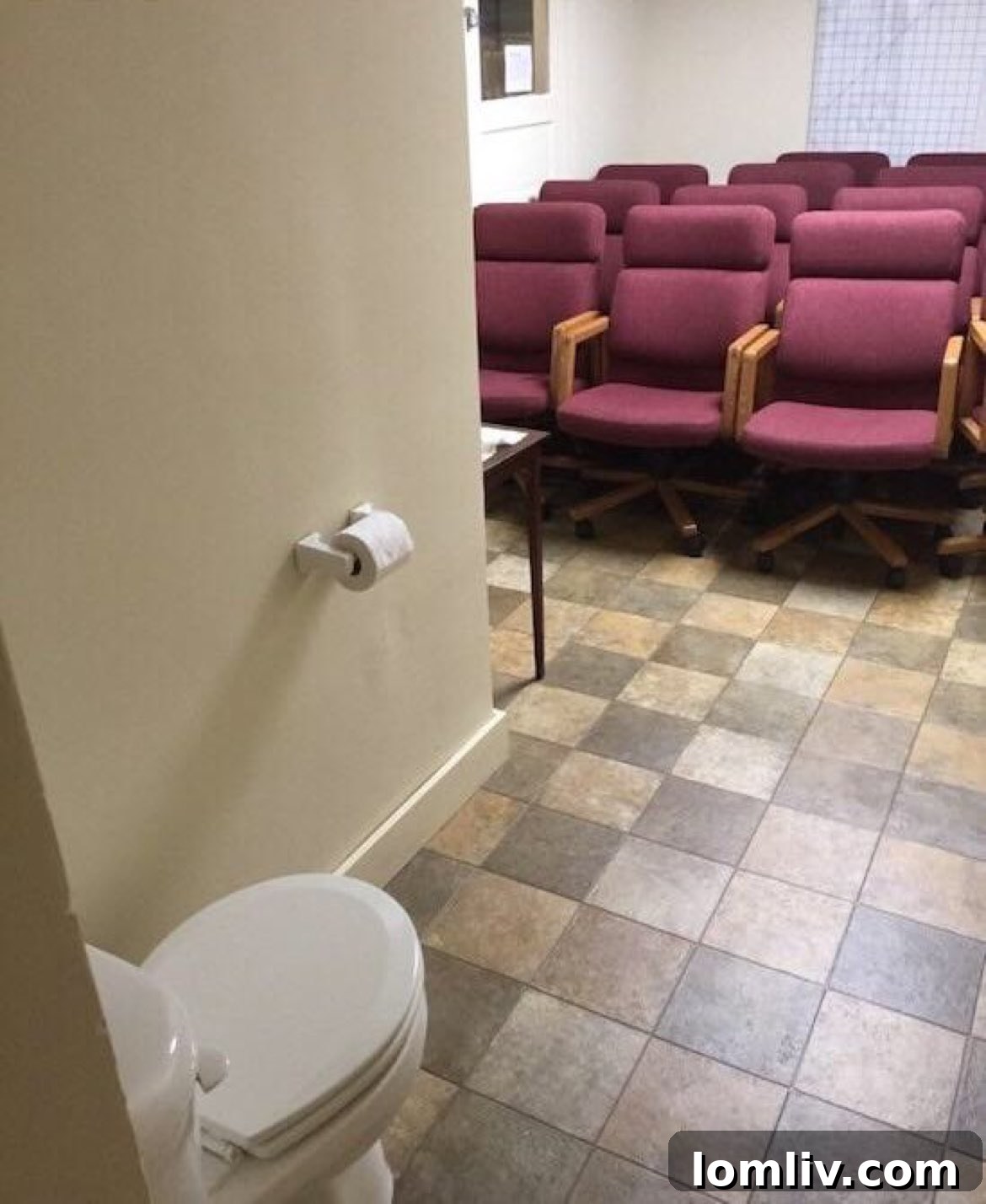 A conference room with a toilet integrated into the meeting table