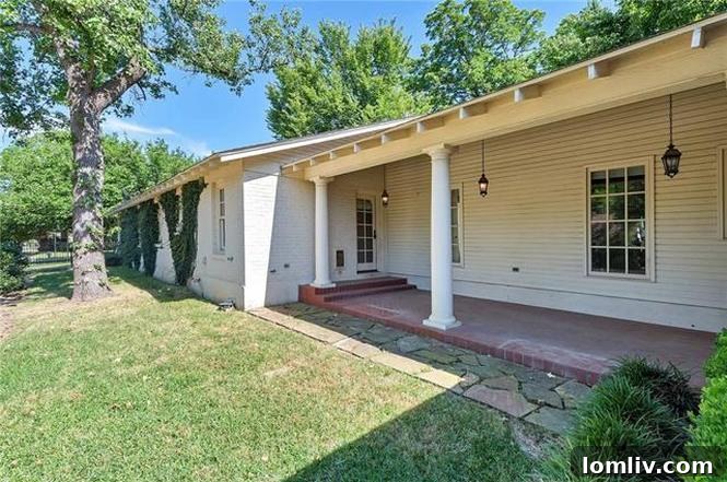 Columned covered porch facing Clarke Avenue, offering a charming outdoor space at 1200 Clover Lane.