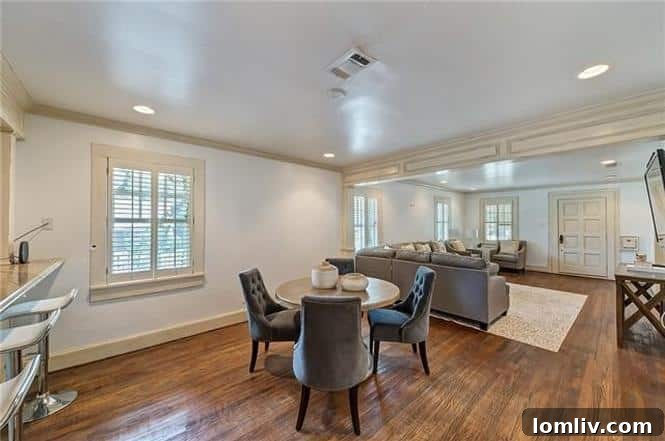 Modern open-concept living area connecting kitchen, dining, and den at 1200 Clover Lane, Fort Worth.
