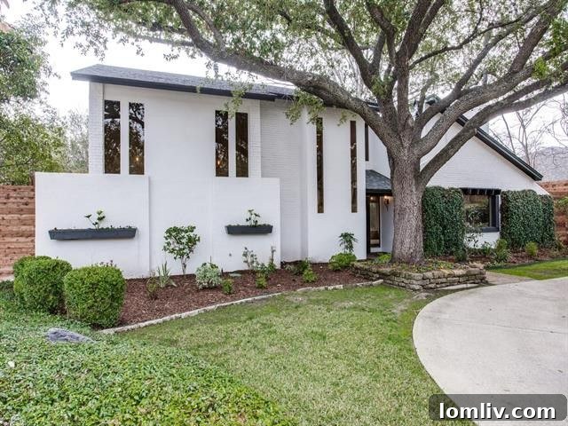 Modern white brick facade with charcoal accents and circular driveway