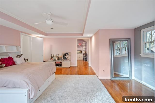 A charming and stylish bedroom featuring a soft pink wall color, reminiscent of classic mid-century design trends.