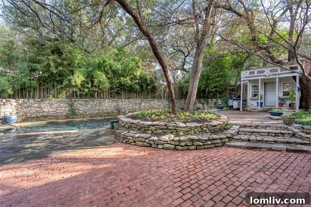 Stunning private garden oasis with a lap pool, spa, outdoor shower, and beautiful dry stack limestone hardscape.