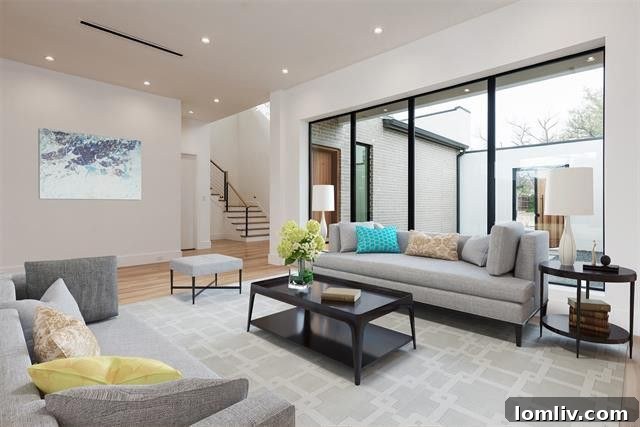Expansive, light-filled great room with a modern fireplace in the Allencrest home