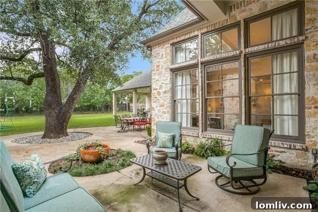 Expansive covered patio with outdoor seating, ideal for entertaining and relaxation.