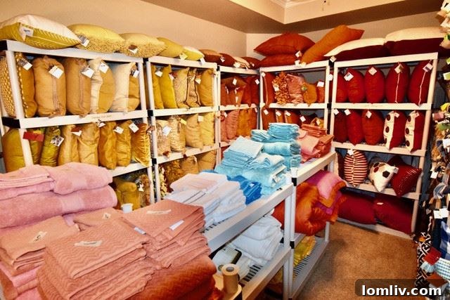 An array of exquisite decorative pillows in various textures and colors, neatly arranged.