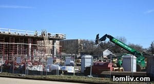 Construction site with heavy machinery, symbolizing the redevelopment of Carriage Square into a modern mixed-use complex in Denton, Texas.
