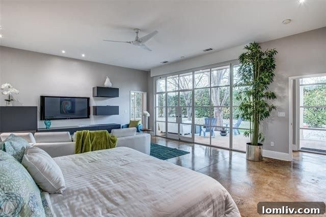 Lush private backyard with terrace and screened porch at 8463 Santa Clara Drive