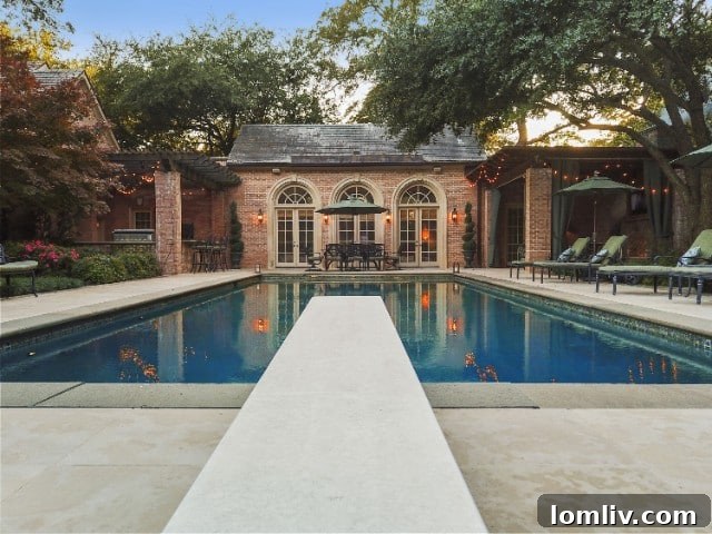 Luxurious outdoor pool area with large screen for movies at 4001 W. Lawther Dr.