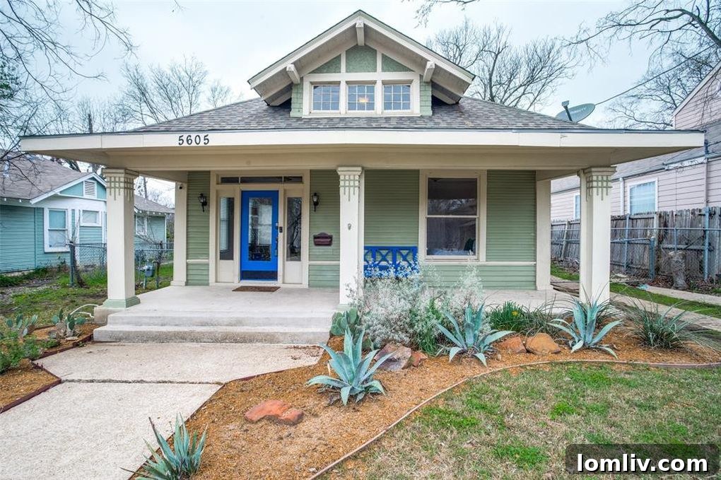 Discover the charm of 5605 Worth St, a beautifully renovated Craftsman home in Dallas's historic Junius Heights. Bright blue accents elevate its curb appeal.