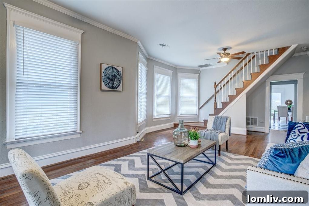 Interior view showcasing the open living and dining area with high ceilings and natural light.
