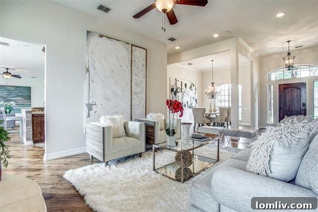 Elegant living room with a striking river-stone fireplace, high ceilings, and abundant natural light in the Boyd, Texas home.