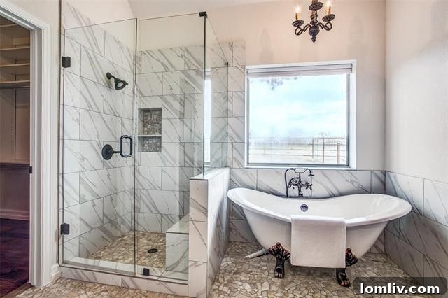 Sleek frameless walk-in shower with modern tiling and design in the master bathroom.