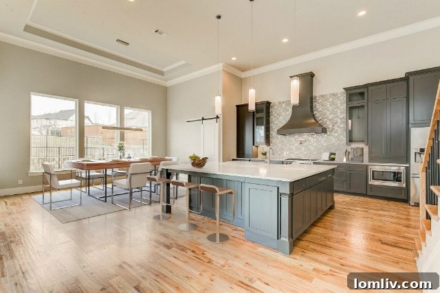 Exquisite kitchen with hardwood floors and large island at 1712 Prairie Ridge Road by MK Homes