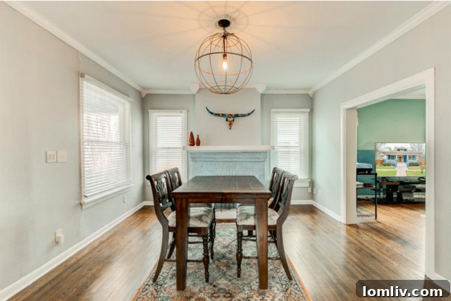 Elegant dining room with fireplace and modern light fixture