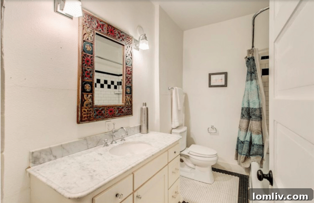 Elegant bathroom with white tiling and wooden vanity