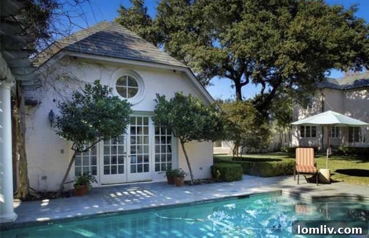 Inviting swimming pool area with a separate cabana at the Highland Park mansion