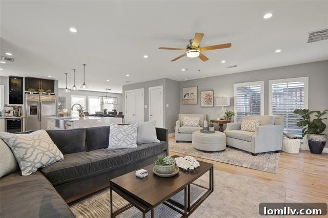 Santa Monica Pool Dreams Come True on San Mateo 4 Stylish open-concept living room with DaVinci fireplace and blonde hardwood floors in a renovated East Dallas home