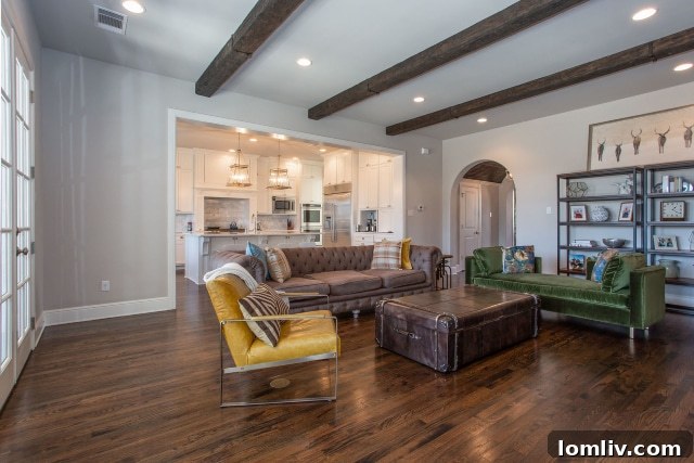 A spacious living room designed with an open-concept floor plan, showcasing modern comfort within a Colonial Revival-inspired home.