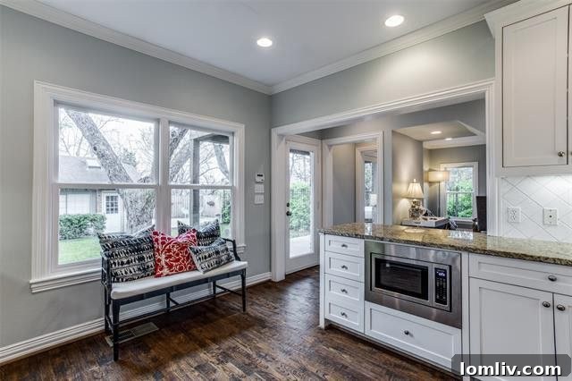 Kitchen island with seating and views of the backyard