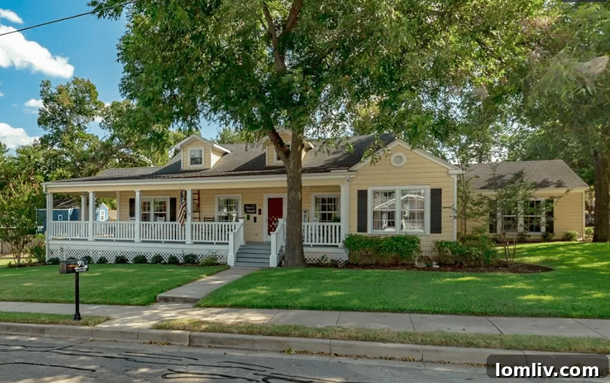Charming early 1900s farmhouse exterior with a wrap-around porch in Weatherford, Texas