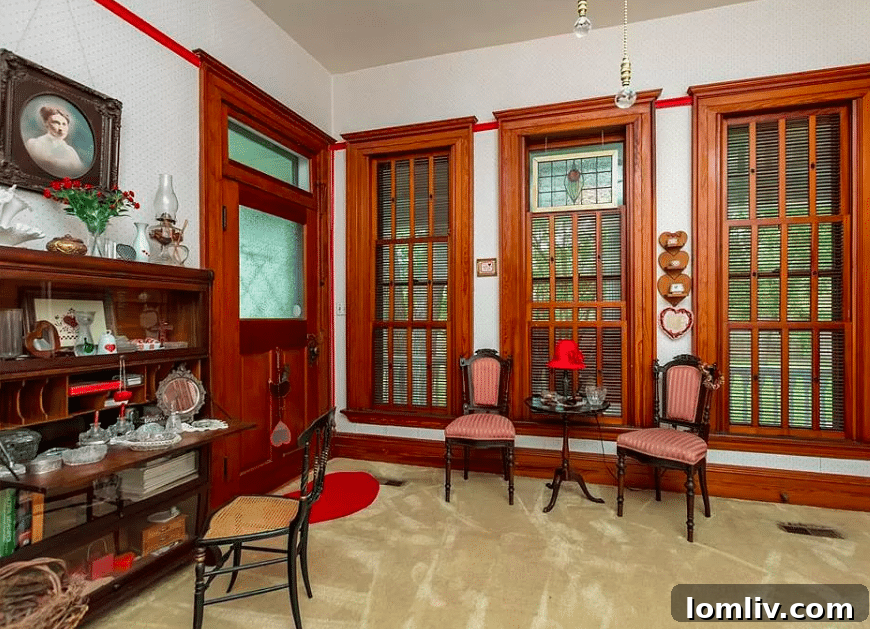 Dining room with fruitwood wainscoting and an original chandelier in the historic Baker Home
