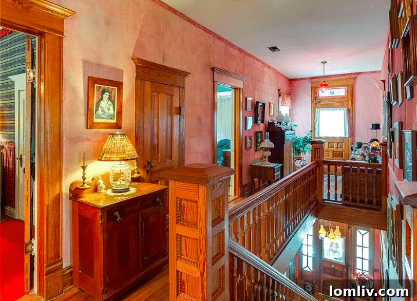 Entrance foyer of the Hood Home with a grand staircase and historic details