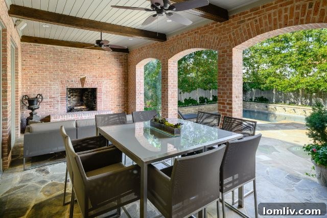 Expansive covered patio with outdoor dining area overlooking the pool
