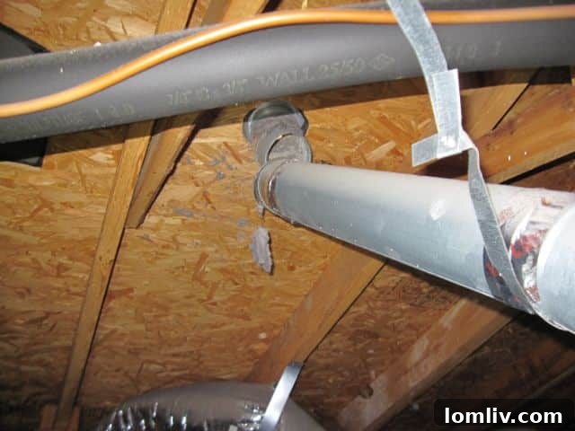 Disconnected dryer duct in an attic, showing lint and hot air being vented into the attic space.