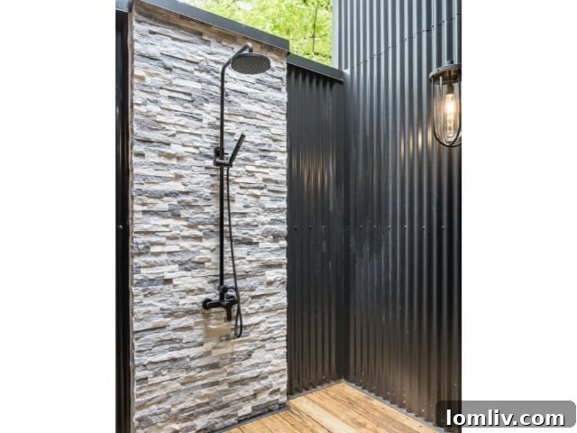Forest Hills Modern Ranch Reimagined 15 Chic outdoor shower surrounded by natural landscaping, offering a refreshing and private experience