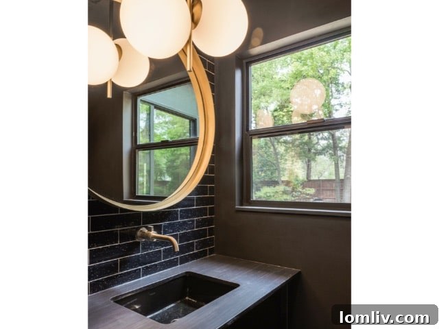 Forest Hills Modern Ranch Reimagined 9 Stylish dining room with modern chandelier and direct views of the serene backyard