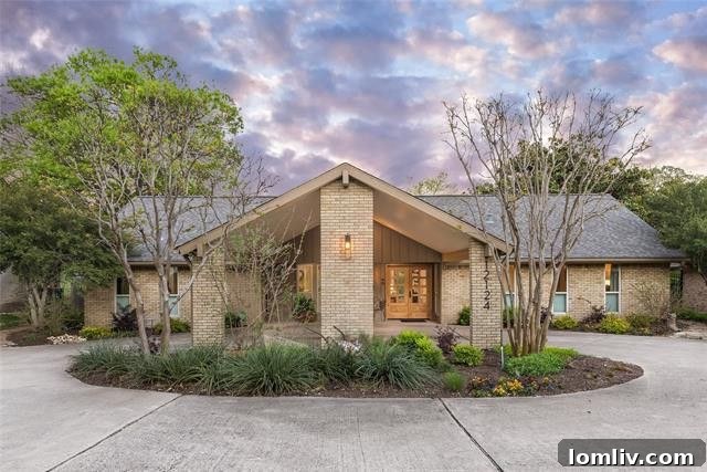 Exterior view of a beautifully renovated ranch home in Lochwood, Northeast Dallas, featuring lush landscaping and modern curb appeal