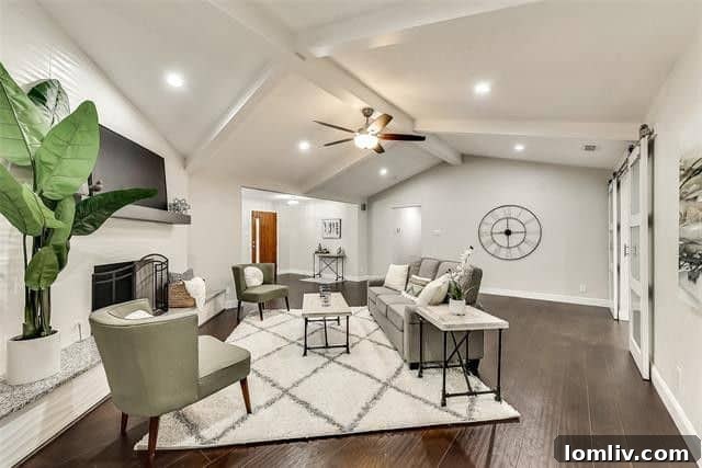 Bright and airy living space in the Lake Highlands ranch home, featuring engineered hardwood floors and vaulted ceilings