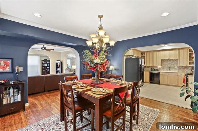 Spacious living area with hardwood floors and natural light in a historic home
