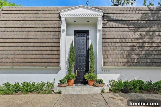 Stunning exterior view of the renovated modern mansard style home at 3707 Prescott