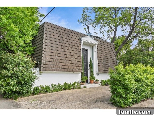 The stunning exterior of the mansard home after renovation, showcasing modern elegance
