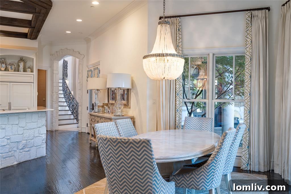 Expansive outdoor patio with columns, separate dining areas, and hanging lights for al fresco entertaining.