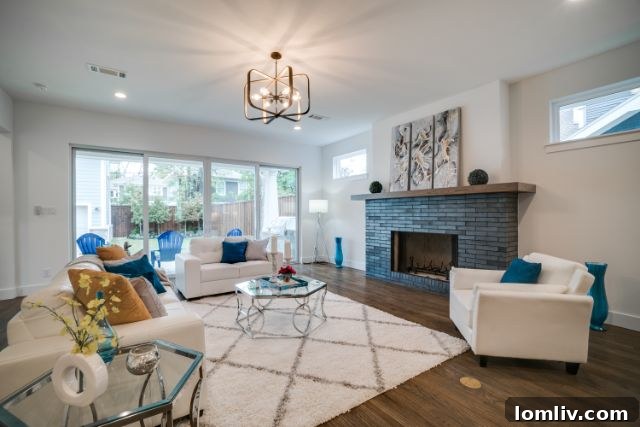 Immaculate New Build, Prime Location 5 Elegant living area with a grand fireplace, connected to a modern kitchen and open layout.
