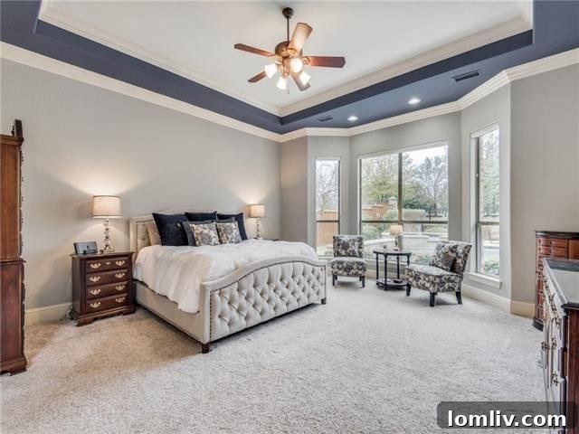 Stunning master bedroom with a sophisticated two-tone tray ceiling design in McKinney, TX