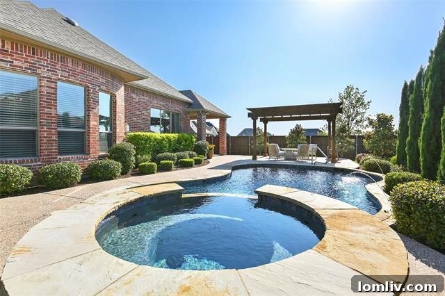 Inviting living space with a charming fireplace, large windows, and comfortable seating in a Prosper home