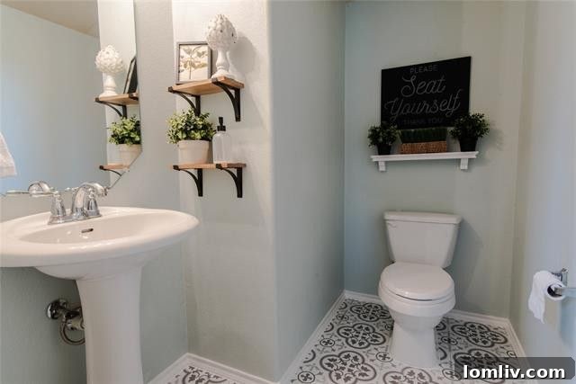 Stylish half bathroom featuring unique patterned tile flooring and a modern vanity in Melissa