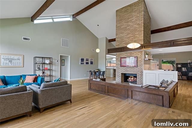 Discover Your Green Oasis in Plano 5 Spacious living room with a large brick fireplace and ample natural light in a Midcentury Modern Plano home.