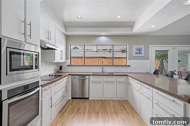 Discover Your Green Oasis in Plano 6 Contemporary kitchen with stainless steel appliances and ample counter space in a Plano home.