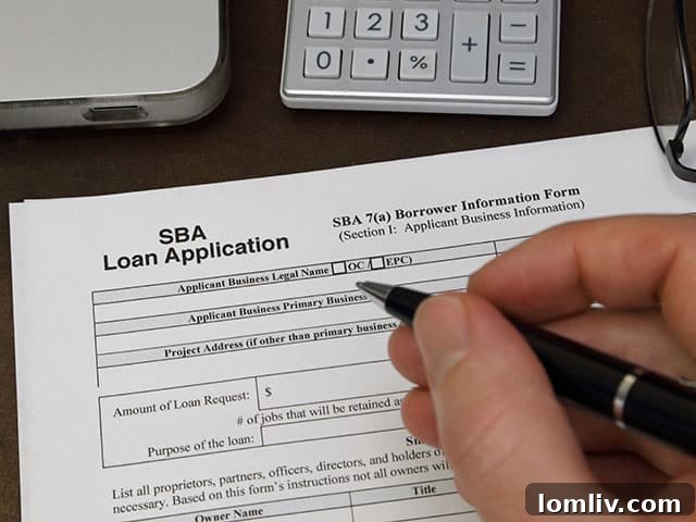 Community Banks Unlock SBA Loan Success 3 Business owner reviewing financial documents for PPP loan application